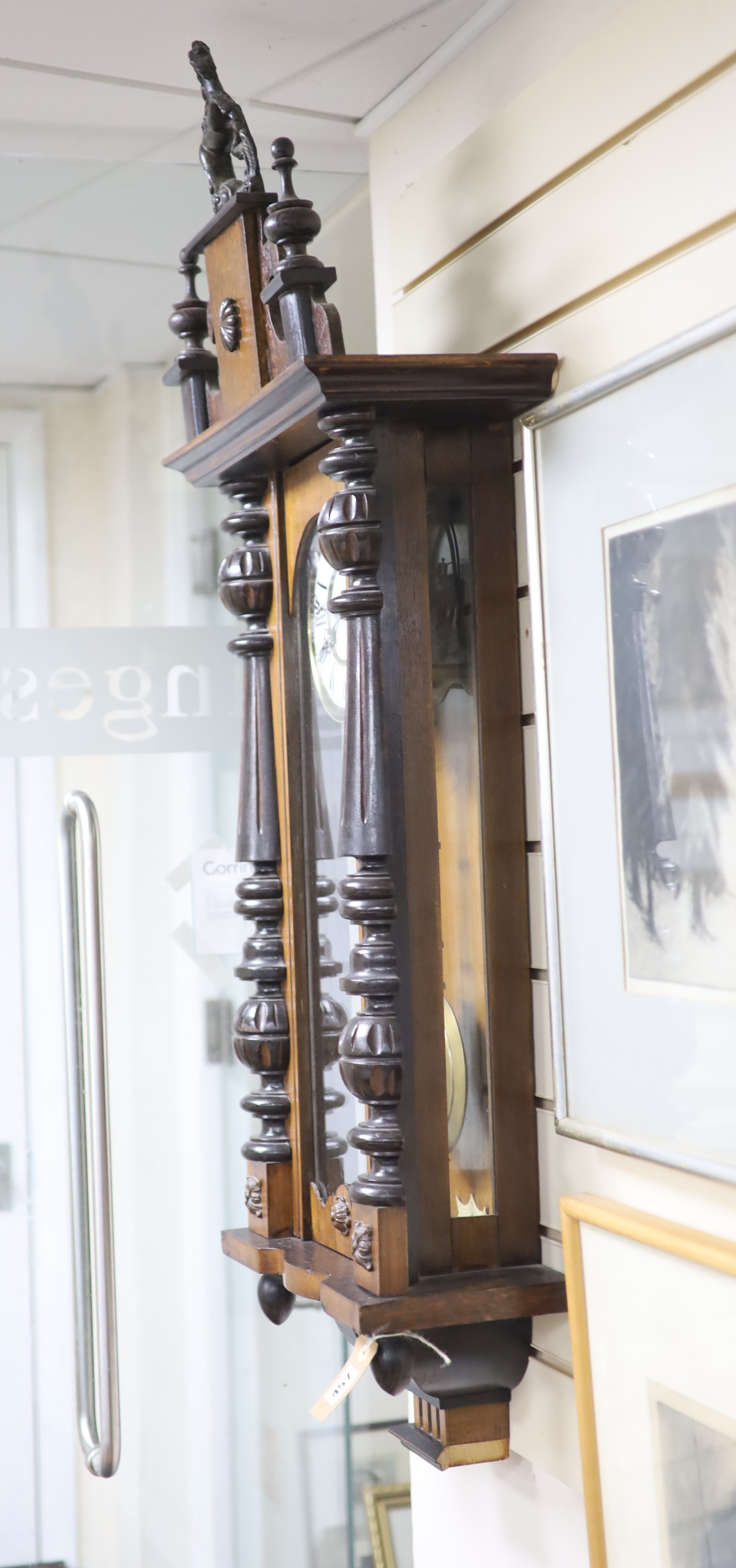 A 19th century Continental regulator in architectural walnut case, with key and gridiron pendulum, 116cm